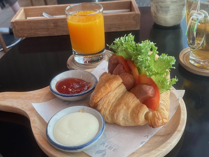 Vibe vegan croissant with sausage and orange juice