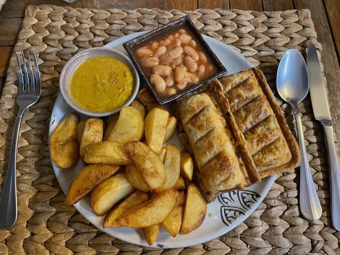 Vegan sausage rolls with chips, beans and curry sauce at New Leaf Eatery