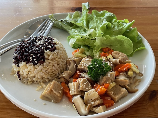 Grow Up Eatery and Farm stir-fried plant-based crispy pork with shiitake mushrooms and brown rice
